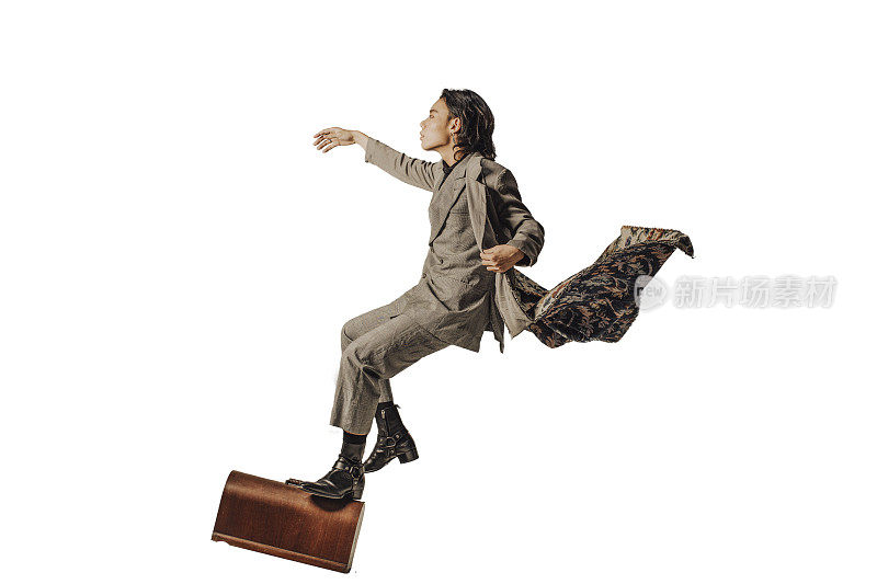 An Asian Chinese male step on a brief case flying